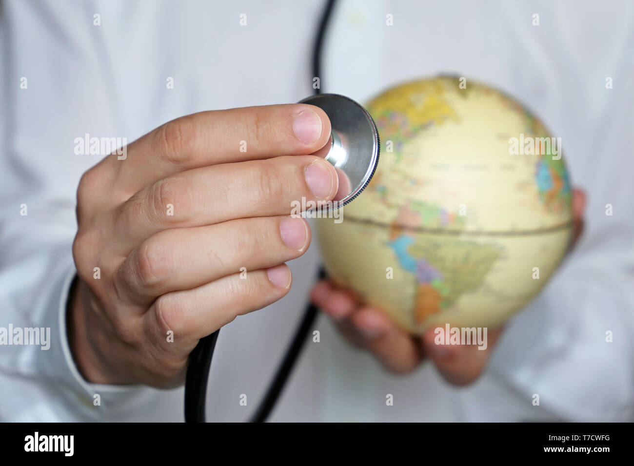 Doctor with stethoscope and globe in his hands. Medical network and health care in US, North and South America, concept of world medicine Stock Photo