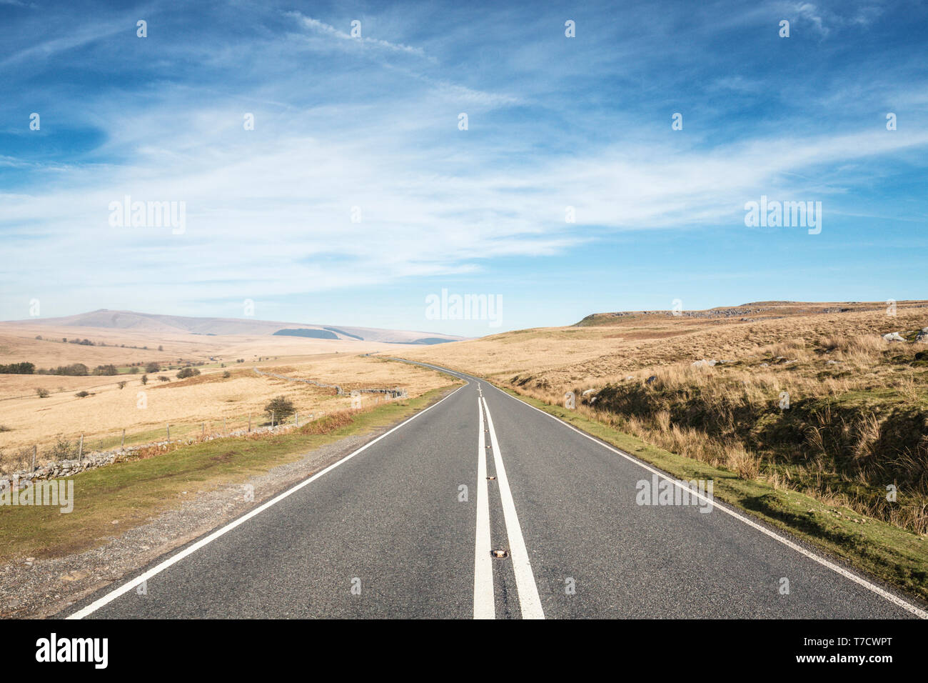 Empty asphalt road across vast hilly landscape of Brecon Beacons in Wales, UK Stock Photo