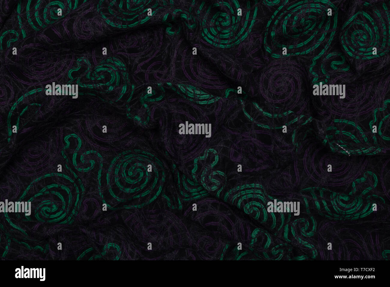 Creative dark fabric with green and violet patterns with textile texture background Stock Photo