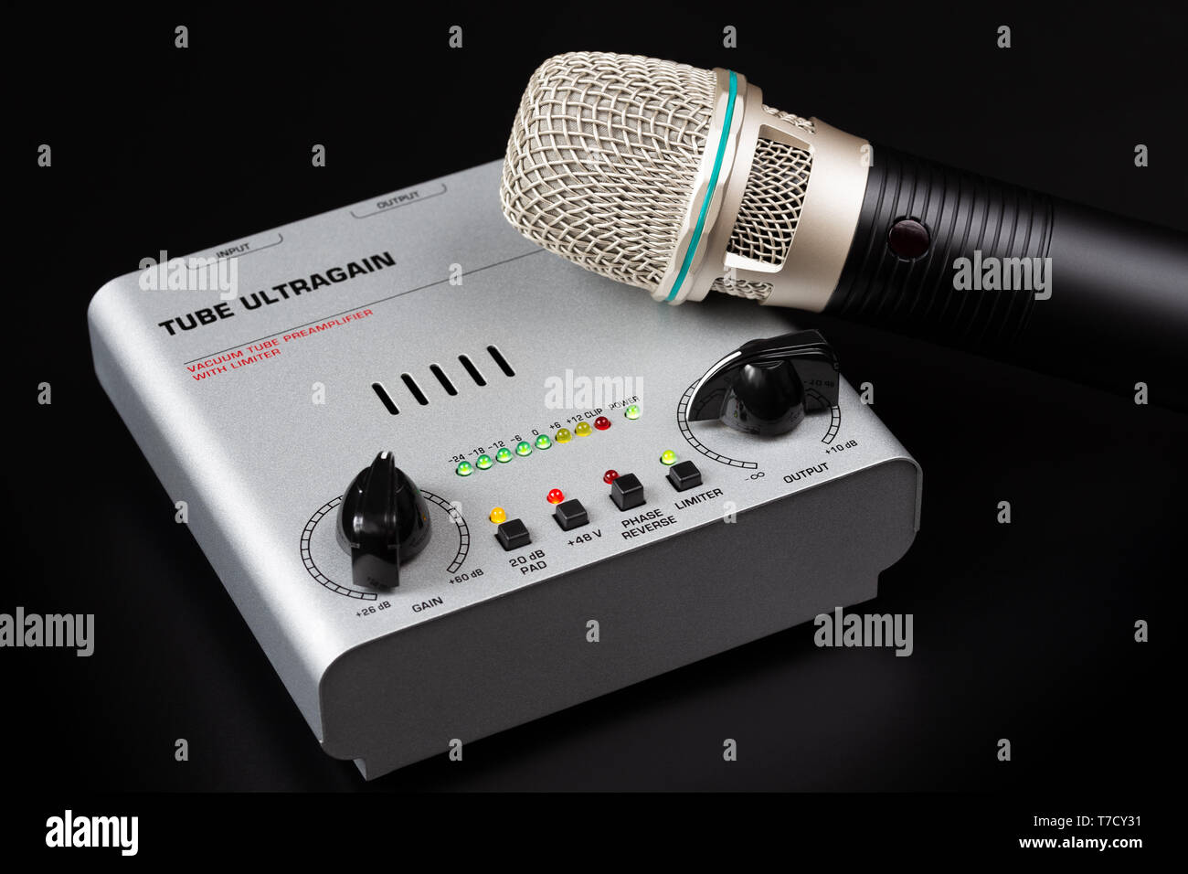 Tube preamp and microphone on a dark background. Stock Photo