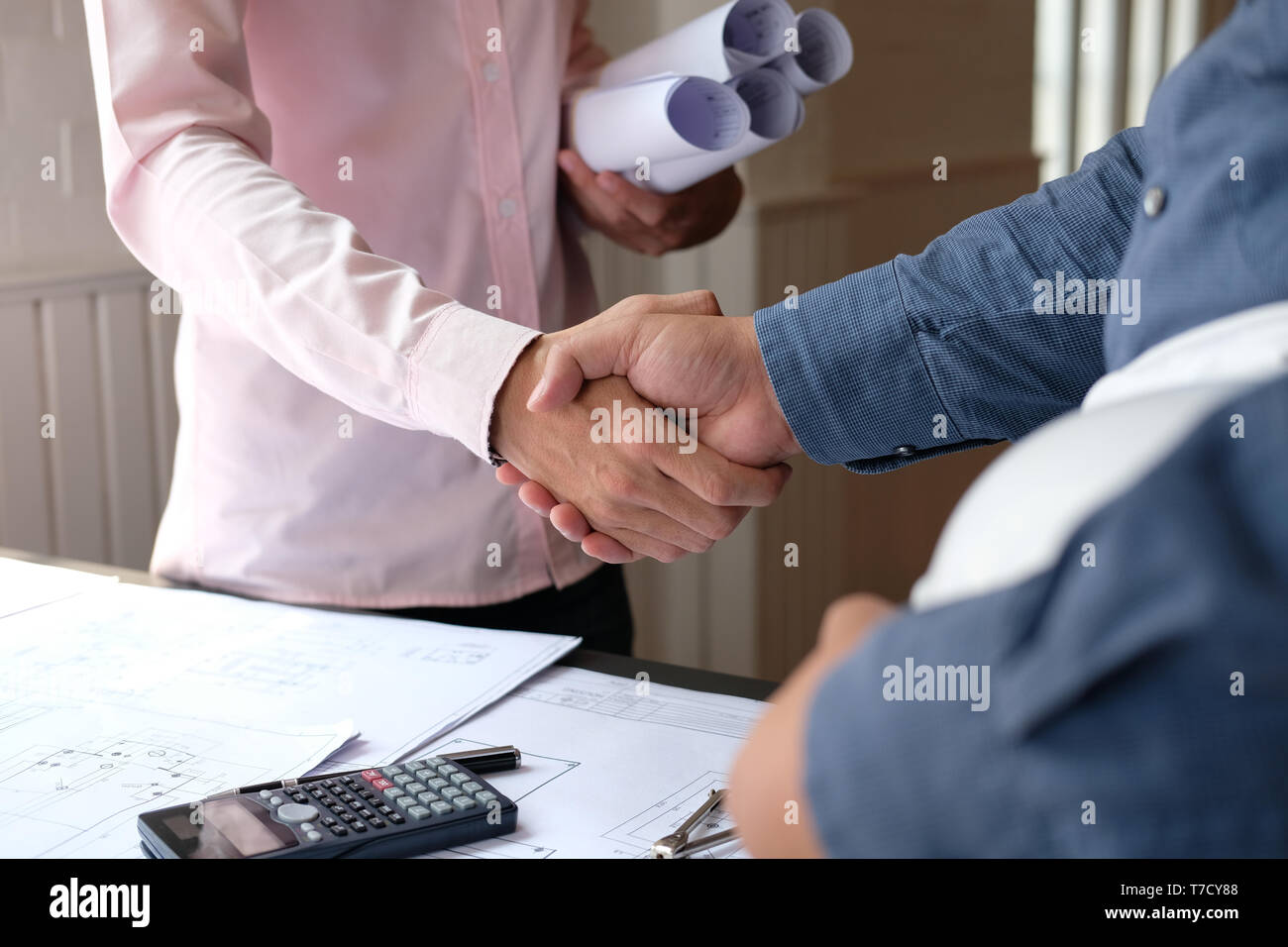 engineer handshaking. architect shaking hands for successful deal in ...