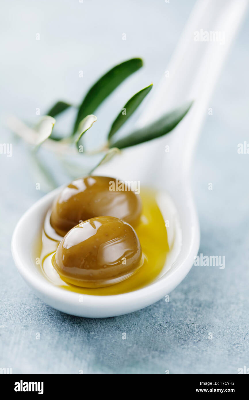 Green olives in oil Stock Photo