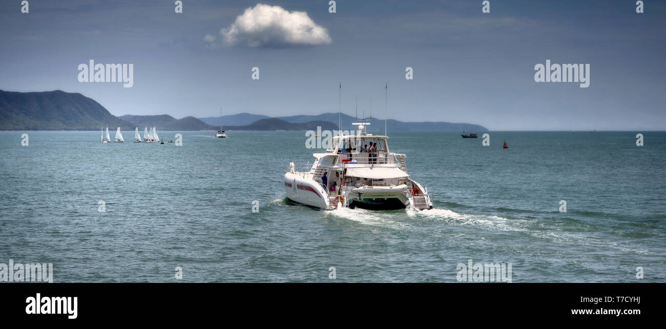 Catamaran tourist boat heading off to distant islands at Pattaya, Thailand tourism, Southeast Asia. Cinematic rendition. Panoramic scene Stock Photo