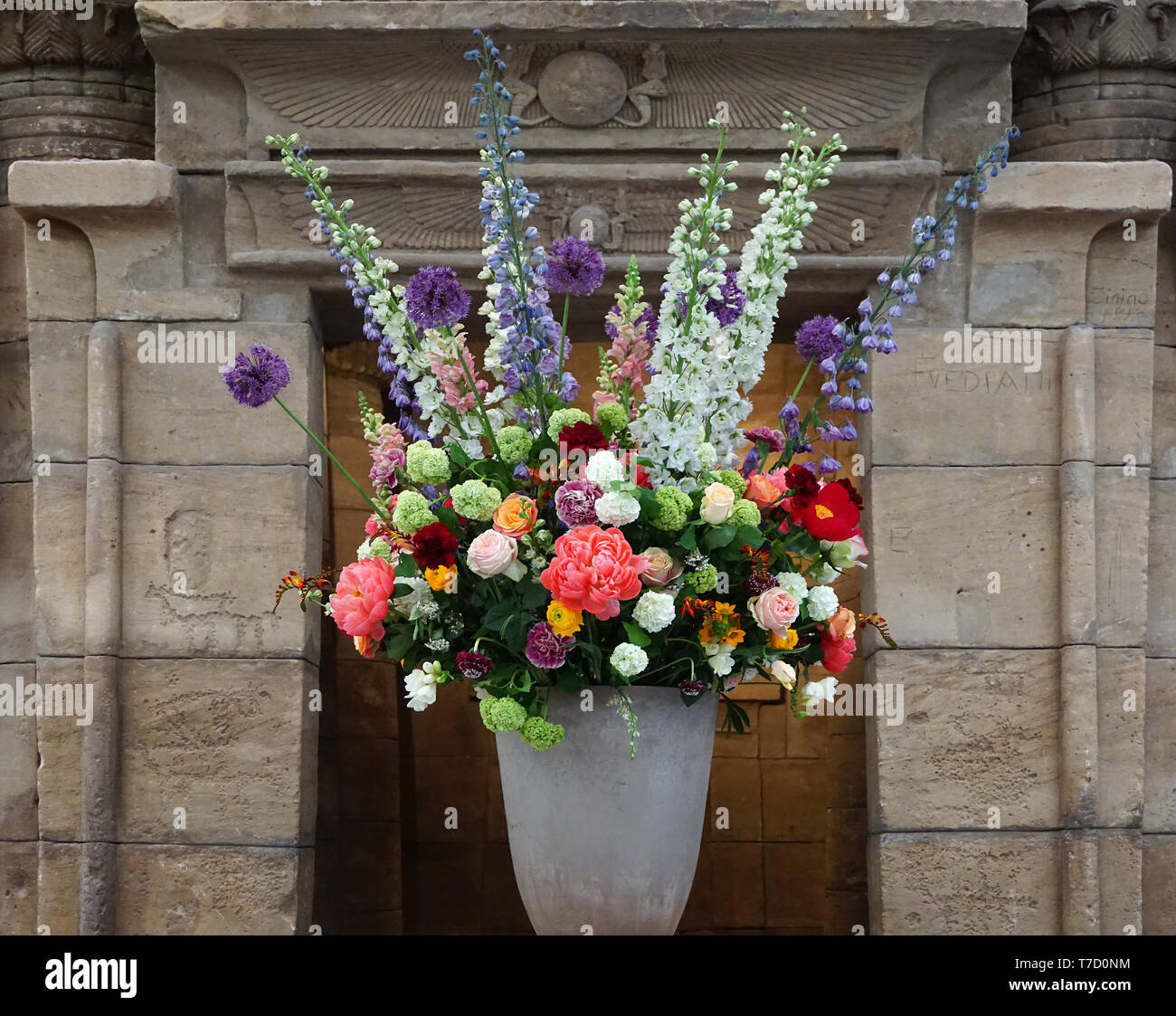 Bouquet of flowers in a vase in front of The Temple of Taffeh (Arabic