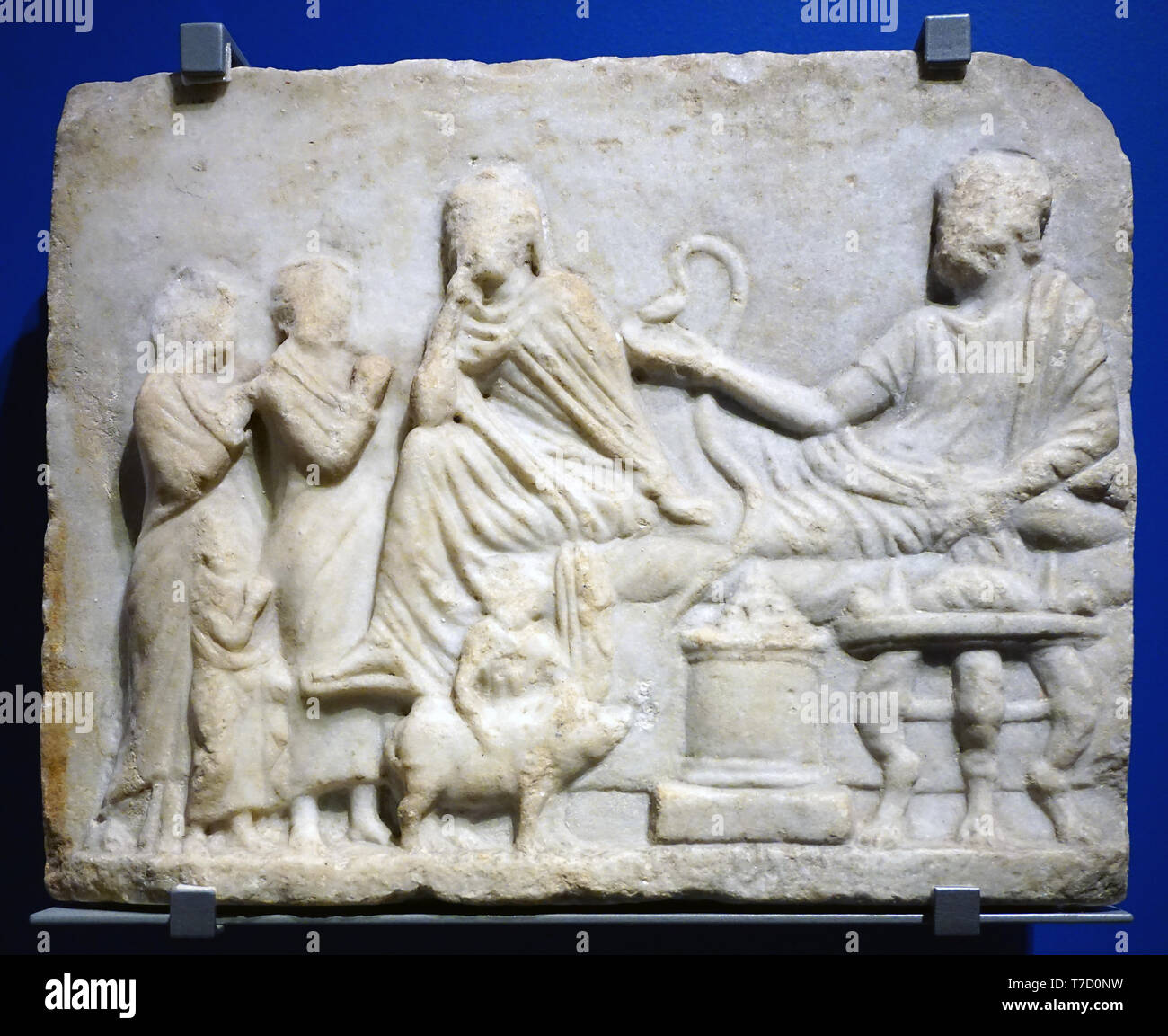 Funerary banquet reliëfs in the ancient greek world.Two heroes honoured with wine,incense and cakes.Attica 300-270 BC Stock Photo