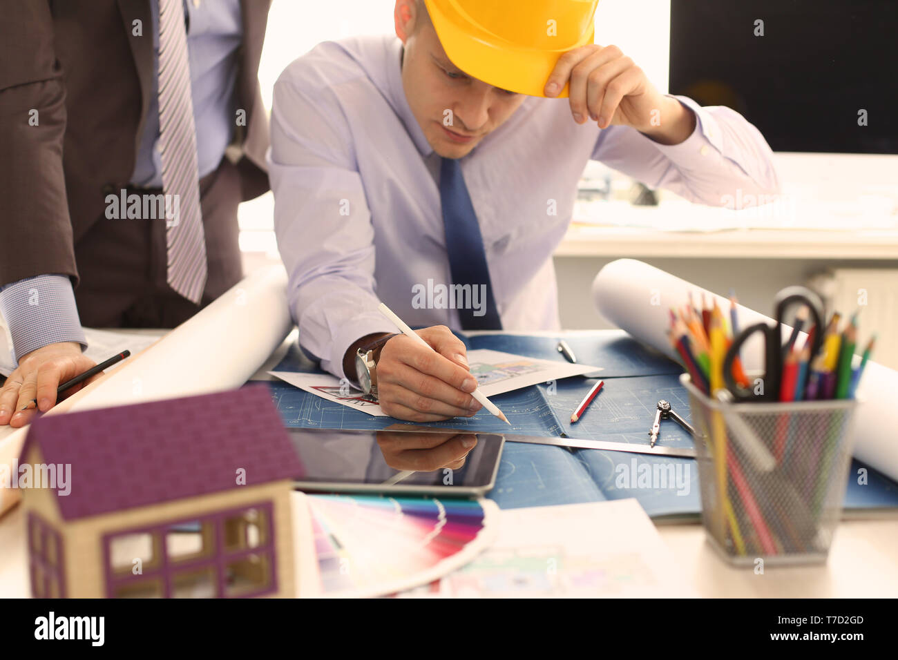 Two Engineer Architect Discussing House Project Stock Photo