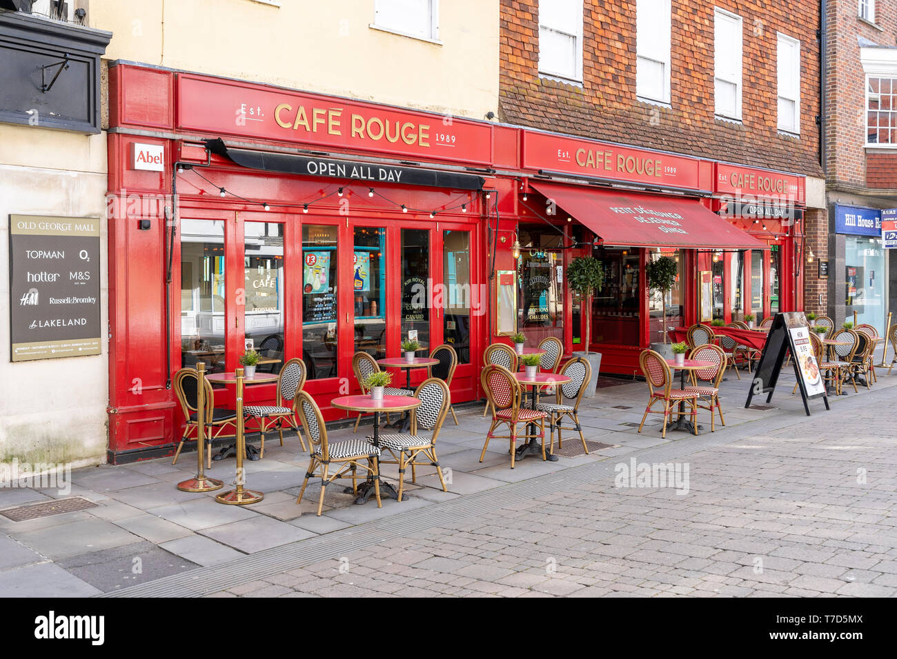 Cafe Rouge restaurant with empty tables and chairs on pavement Stock Photo