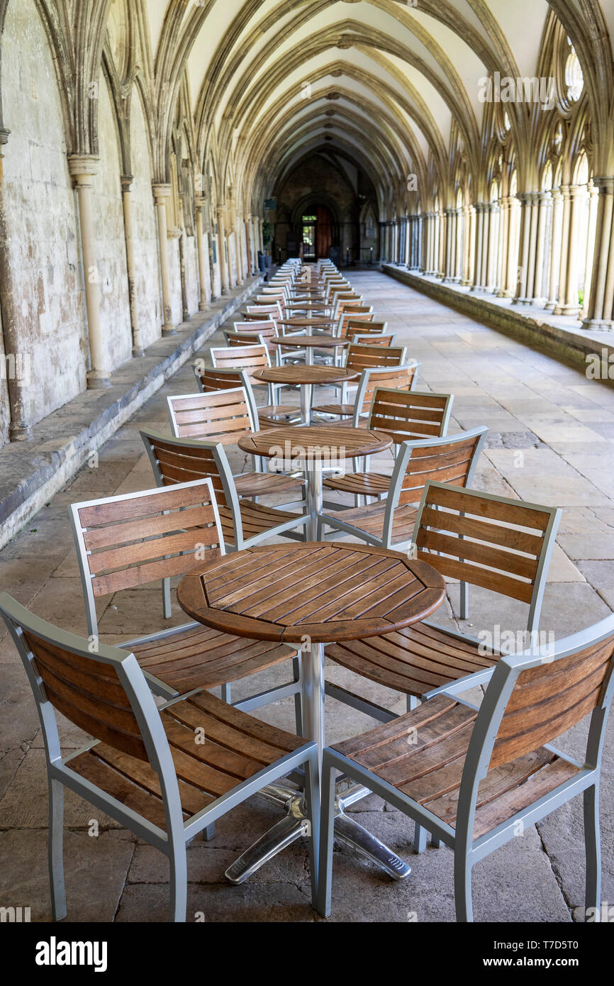 Empty tables and chairs in Salisbury cathedral cloisters Stock Photo