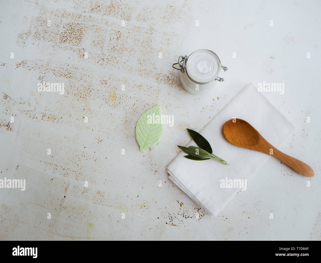 Homemade DIY vegan deodorant in a glass jar with ingredients on the