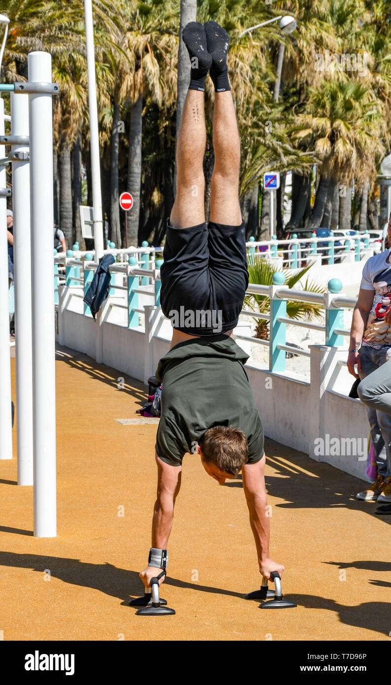 CANNES, FRANCE APRIL 2019 Person doing a handstand at an outdoor gym