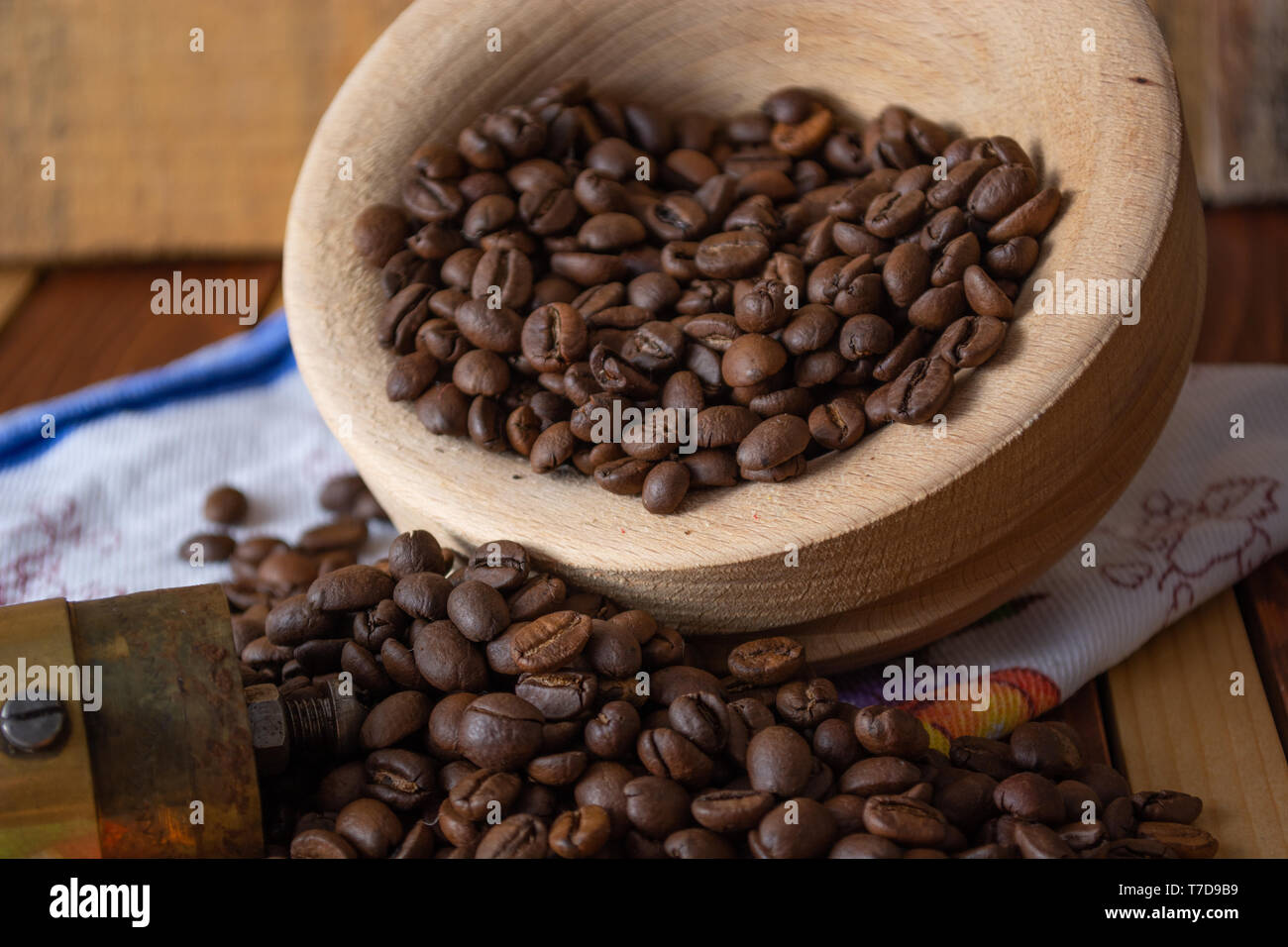 Coffee ready to be milled with old grinder. Coffee is in the table Stock Photo