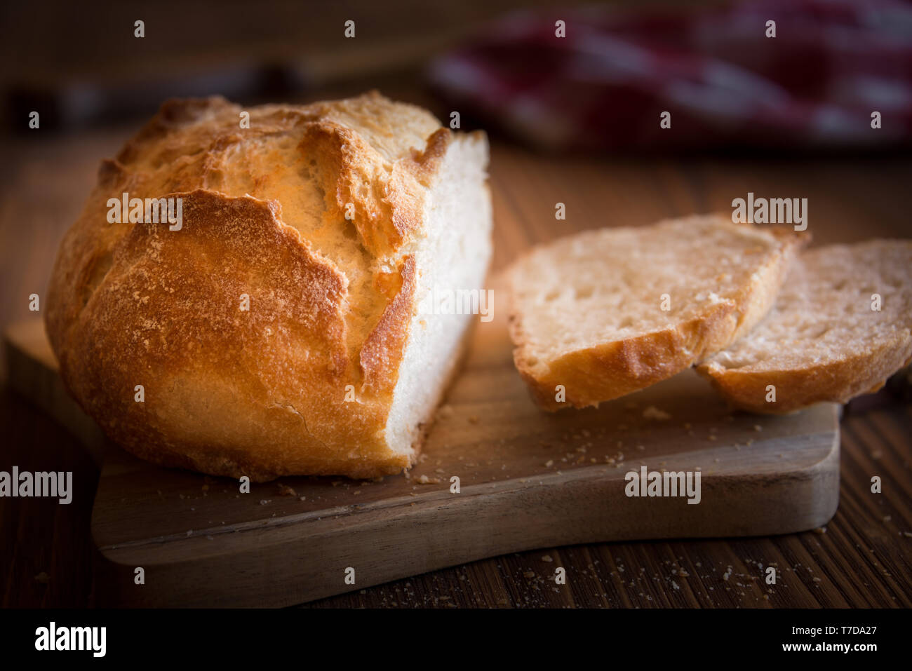 Homemade loaf of sliced wheat bread on wooden table Stock Photo - Alamy