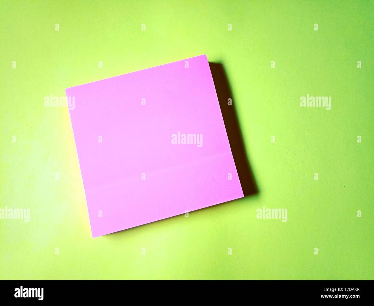 Blank pink stick note isolated on yellow background Stock Photo
