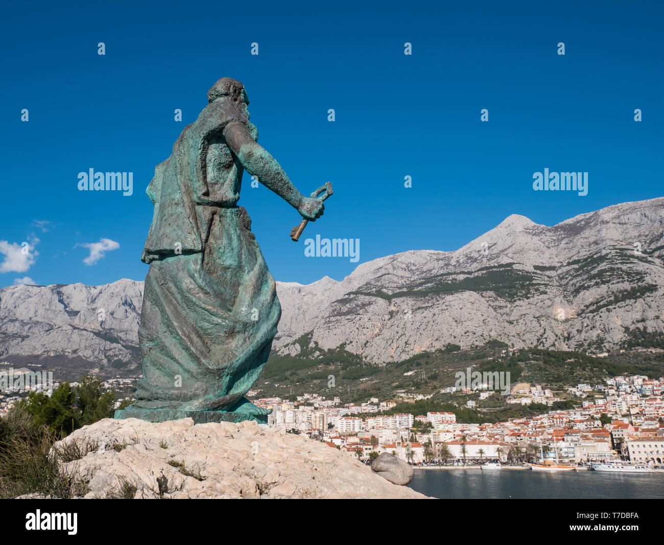 Editorial - Saint Peter monument in front of Makarska city on sunny day Stock Photo