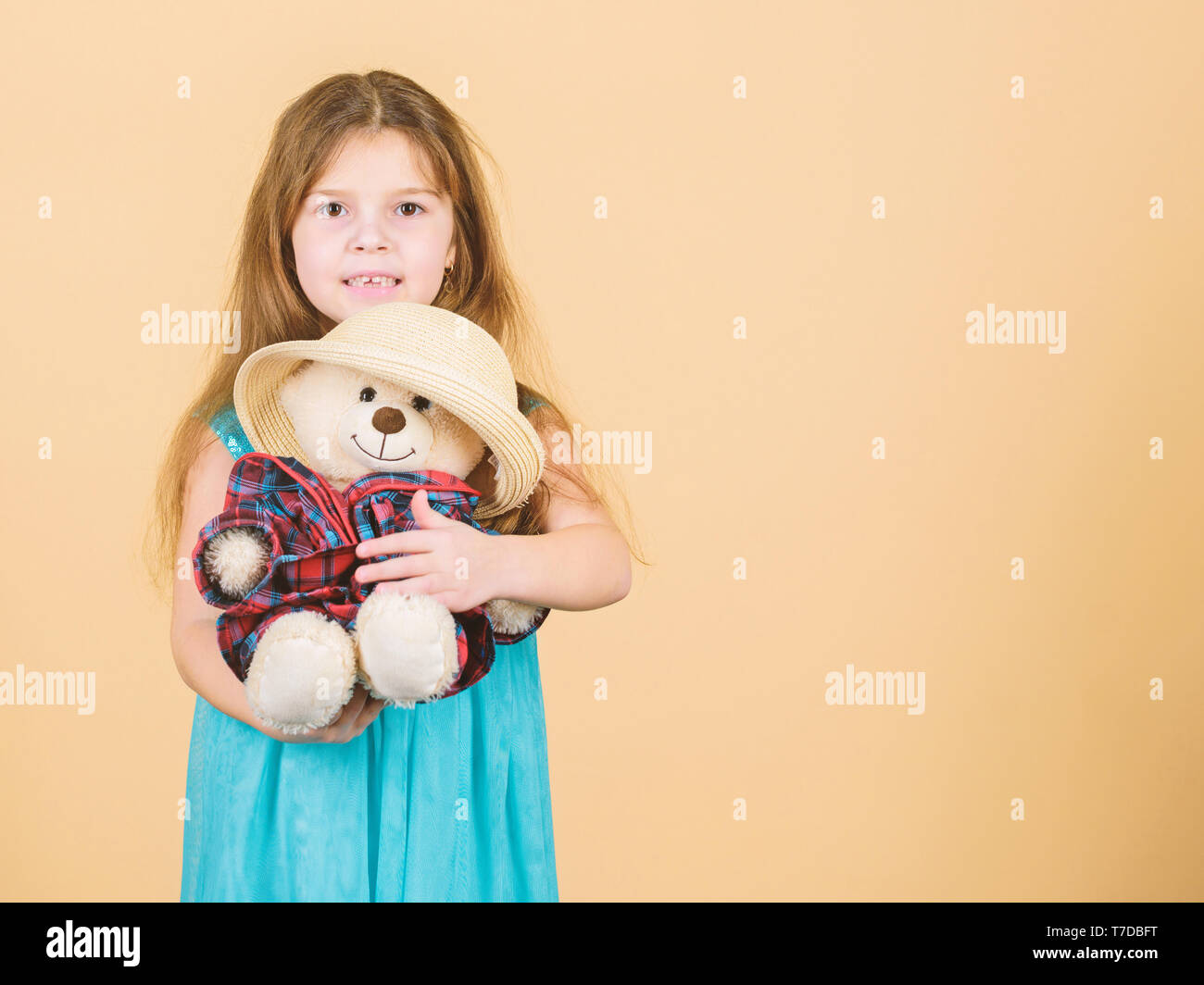 Cutest ever. Kid little girl carefully hug soft toy teddy bear beige ...
