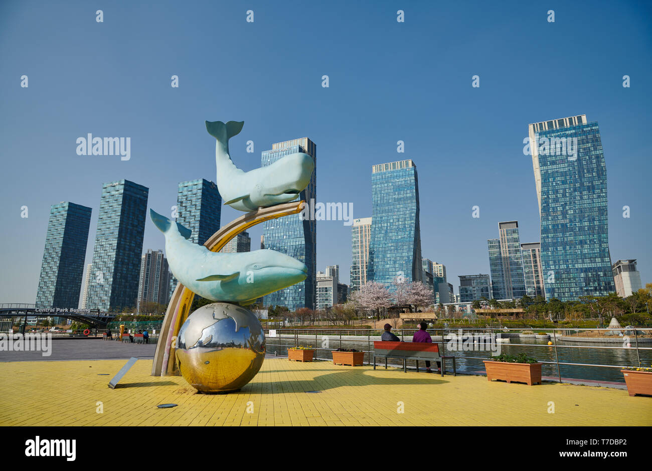 whale figures in Central Park of Songdo International Business District with skyscraper in the back, Incheon City, South Korea Stock Photo