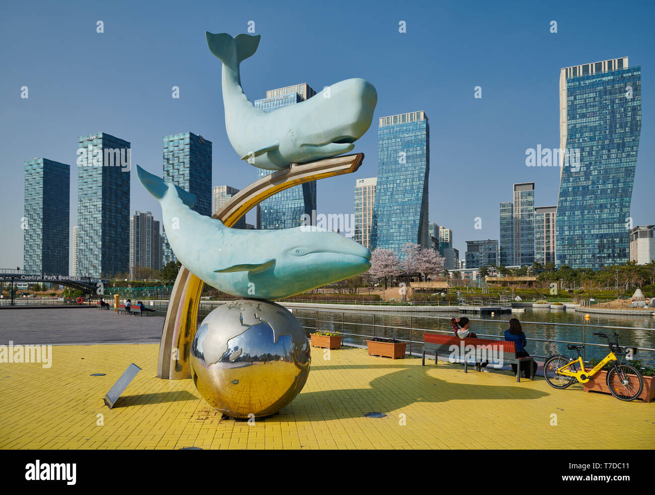 whale figures in Central Park of Songdo International Business District with skyscraper in the back, Incheon City, South Korea Stock Photo