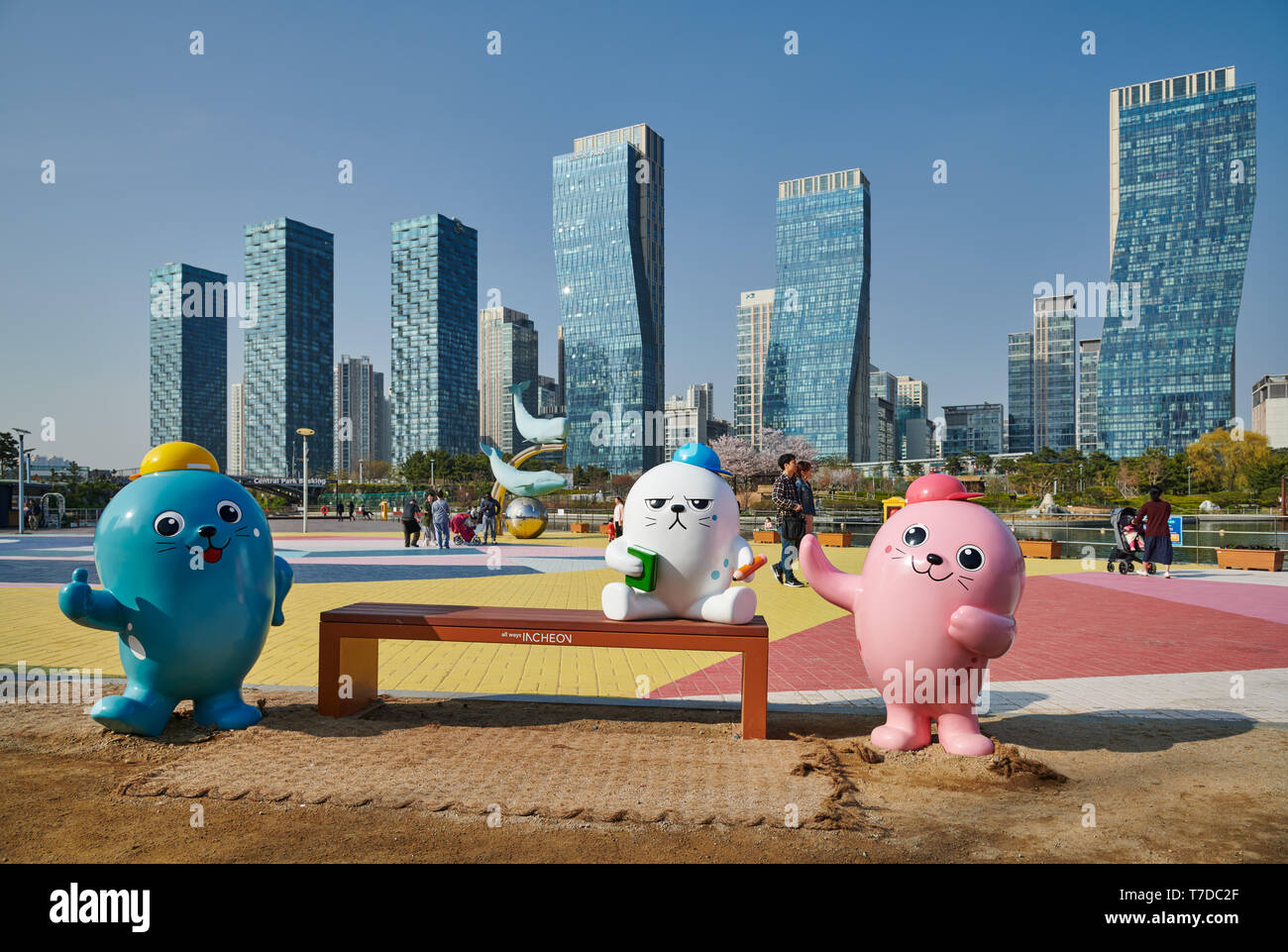 oversized colorful toy figures in Central Park in Songdo International Business District with skyscraper in the back, Incheon City,  South Korea Stock Photo