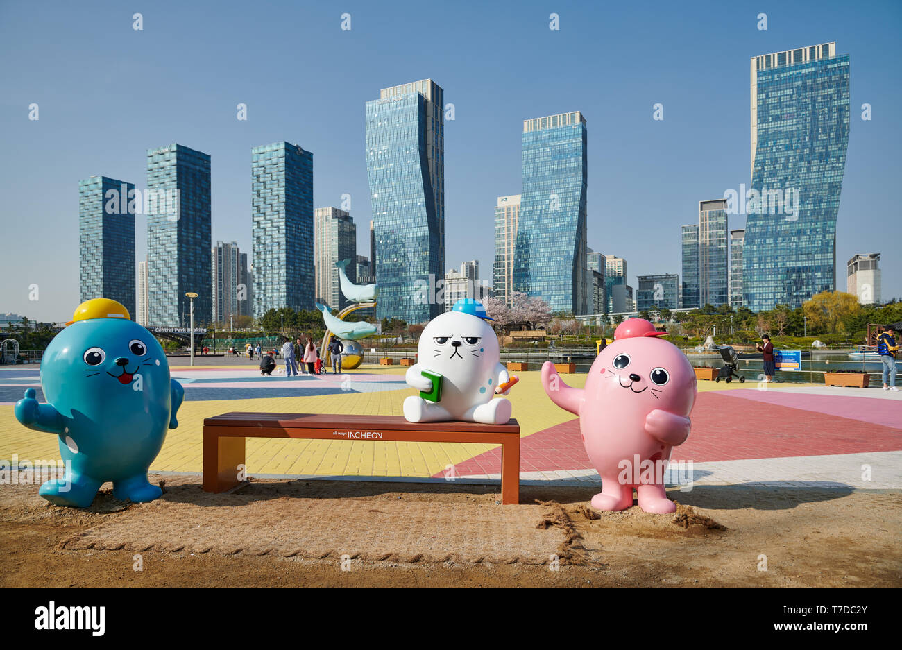 oversized colorful toy figures in Central Park in Songdo International Business District with skyscraper in the back, Incheon City,  South Korea Stock Photo