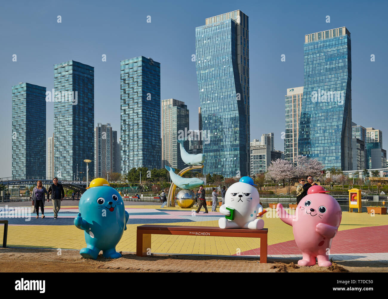 oversized colorful toy figures in Central Park in Songdo International Business District with skyscraper in the back, Incheon City,  South Korea Stock Photo
