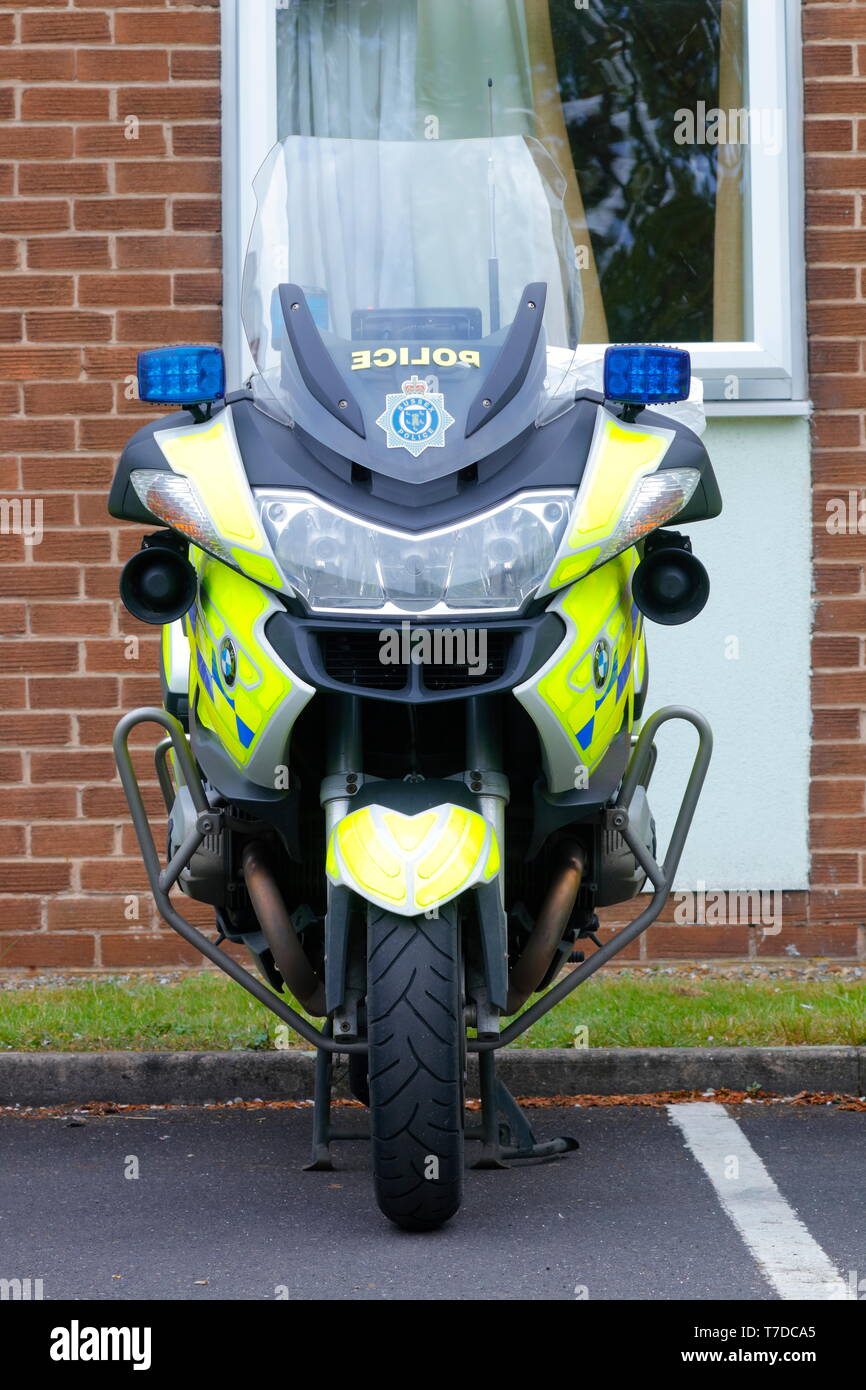 A BMW police motorcycle parked up , before setting off in convoy to