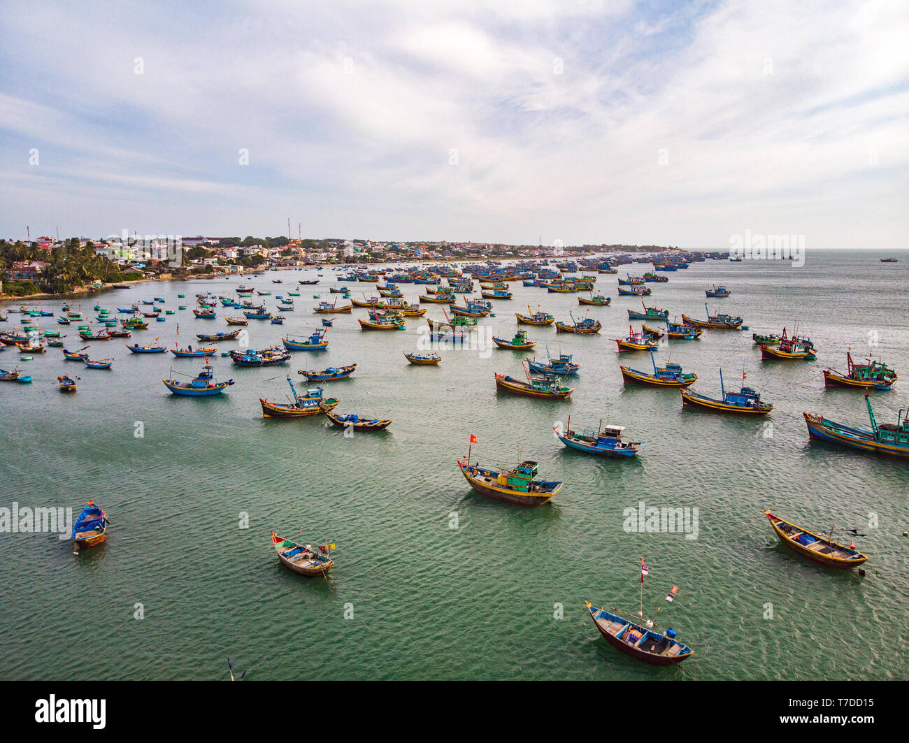 What a many boat on this beach, Mui Ne, Vietnam. On a sunny day in southern Vietnam, crowd of fishermen boats getting back from piscatory waiting for  Stock Photo