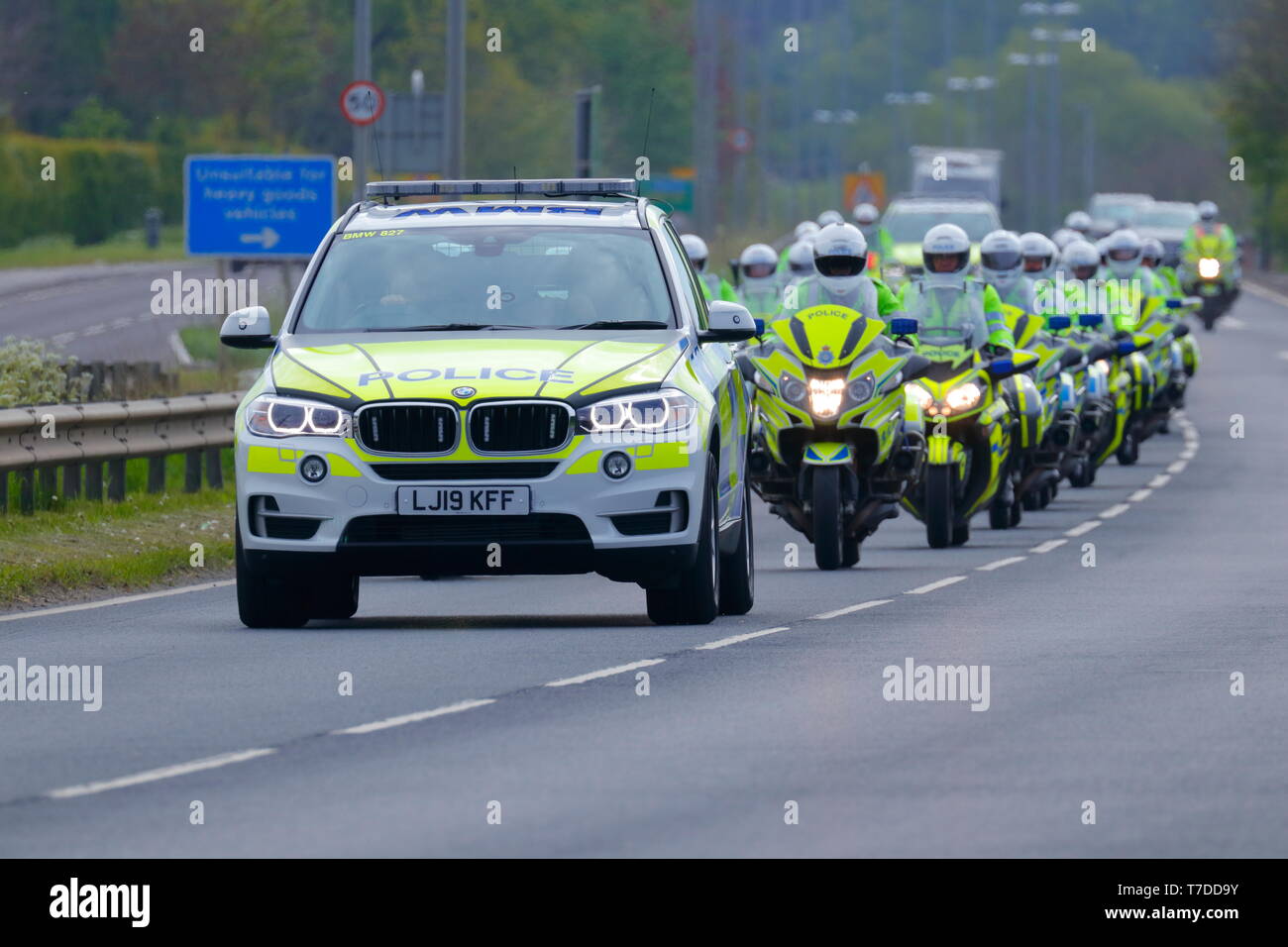 Police convoy travelling through Swillington Common to escort Tour De