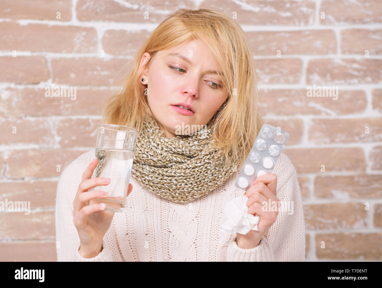 Medicines can give her some relief. Sick girl taking anti cold pills