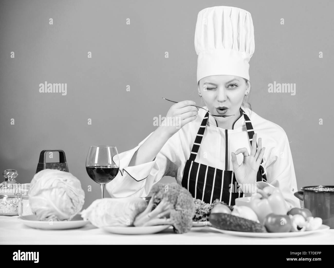 Girl in hat and apron. Cooking healthy food. Fresh vegetables