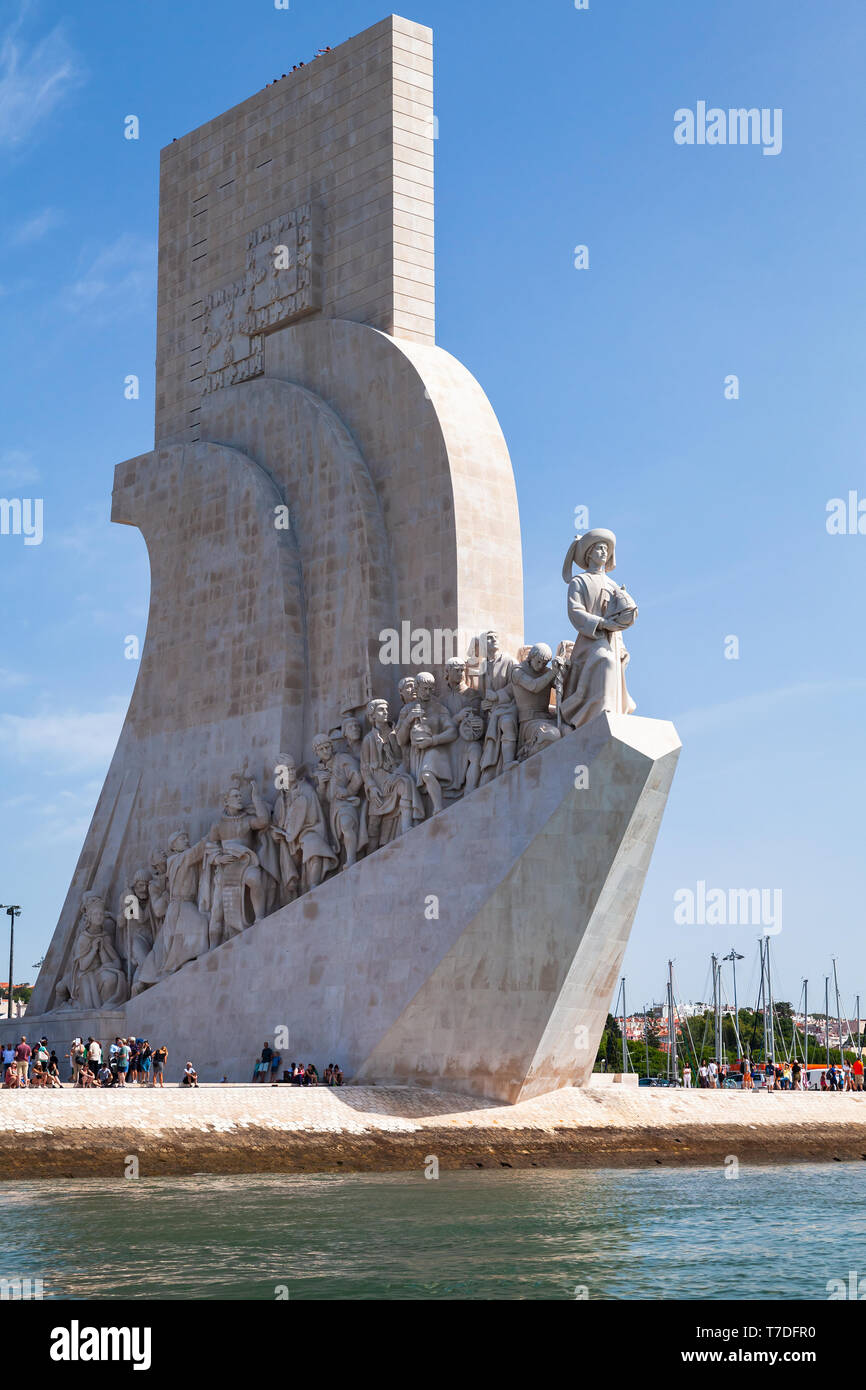 Lisbon, Portugal - August 15, 2017: Tourists walk near Monument of the Discoveries on the northern bank of the Tagus River in Lisbon Stock Photo