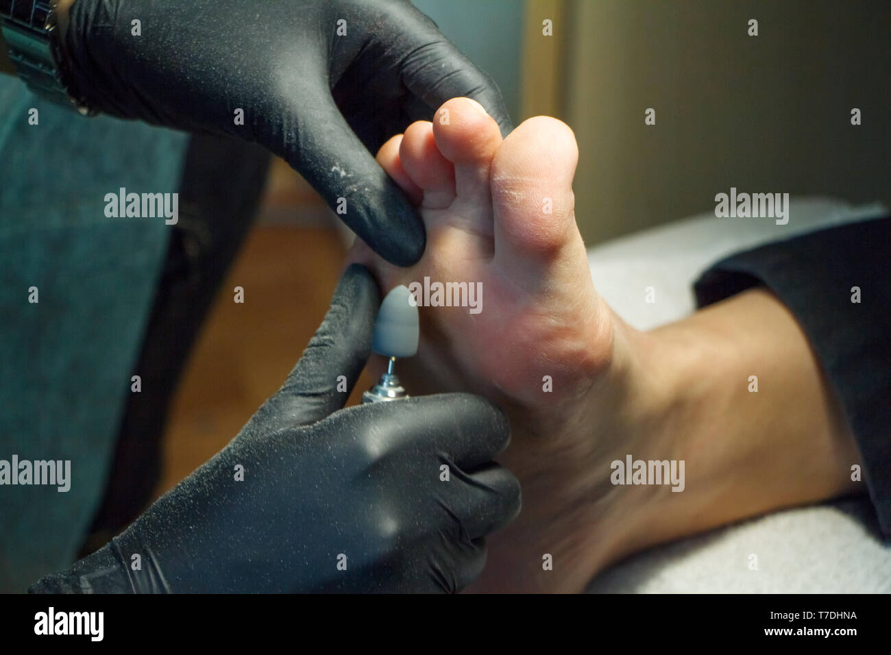 Professional hardware pedicure using electric machine.Patient on