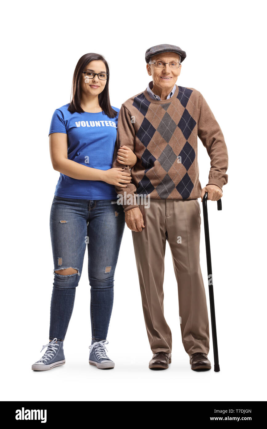 Full length portrait of a young woman volunteer standing with a senior male pensioner with a walking cane isolated on white background Stock Photo