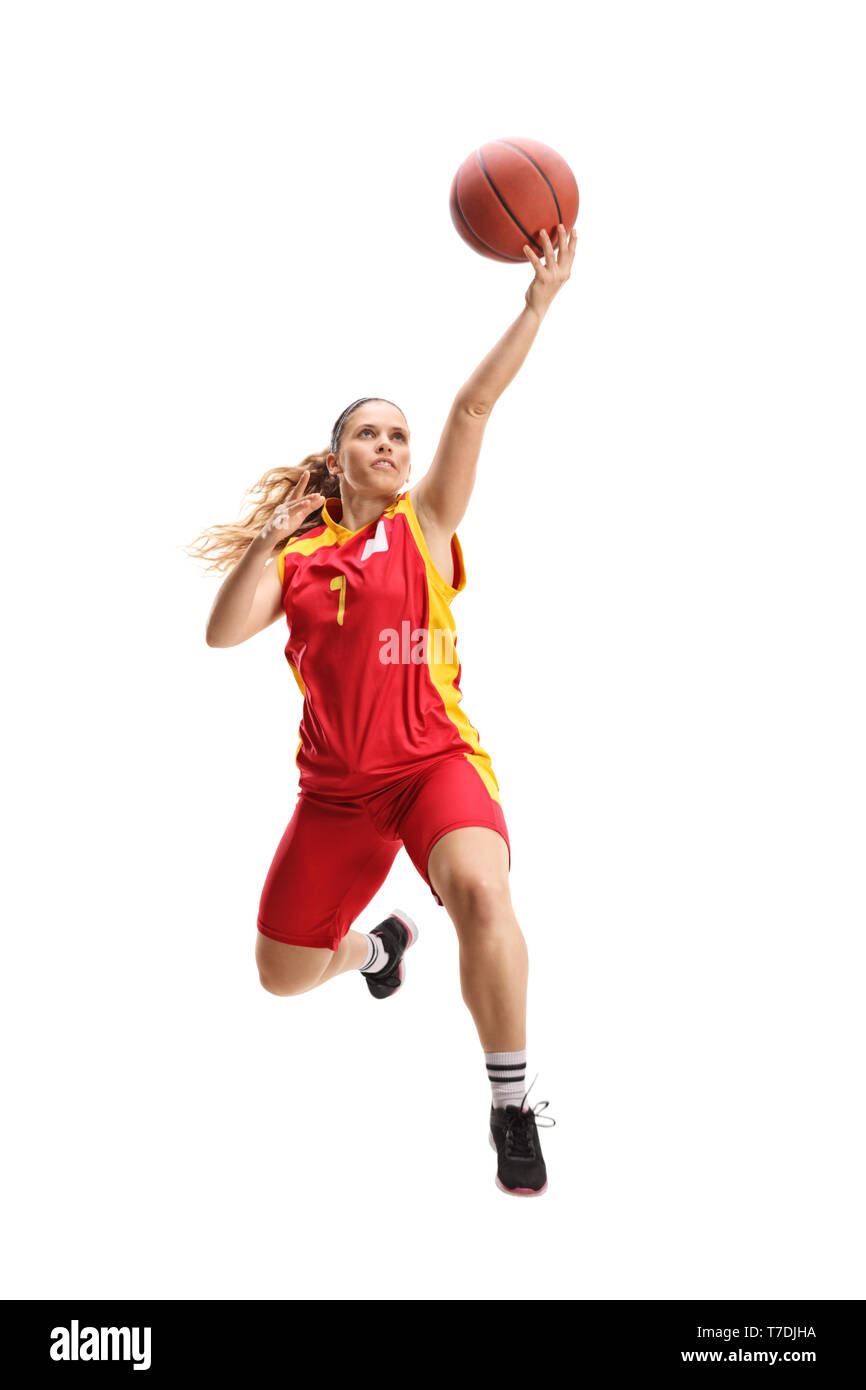 Full length portrait of a female basketball player jumping with a ball