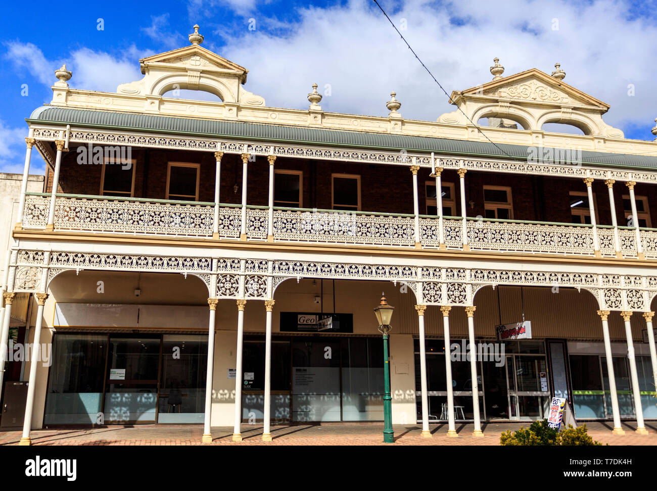Detail of the heritage listed Imperial Hotel built in 1889 and ornamented with cast-iron friezework,  bullnose awnings and parapets with Grecian urns  Stock Photo