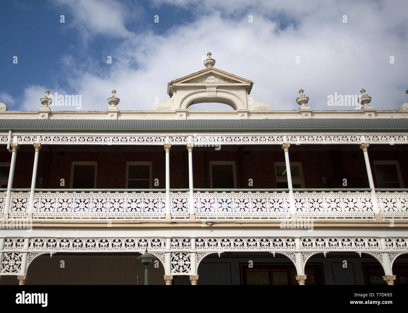 Detail of the heritage listed Hotel built in 1889 and ornamented with cast-iron friezework, bullnose awnings and parapets with Grecian urns and pedime Stock Photo