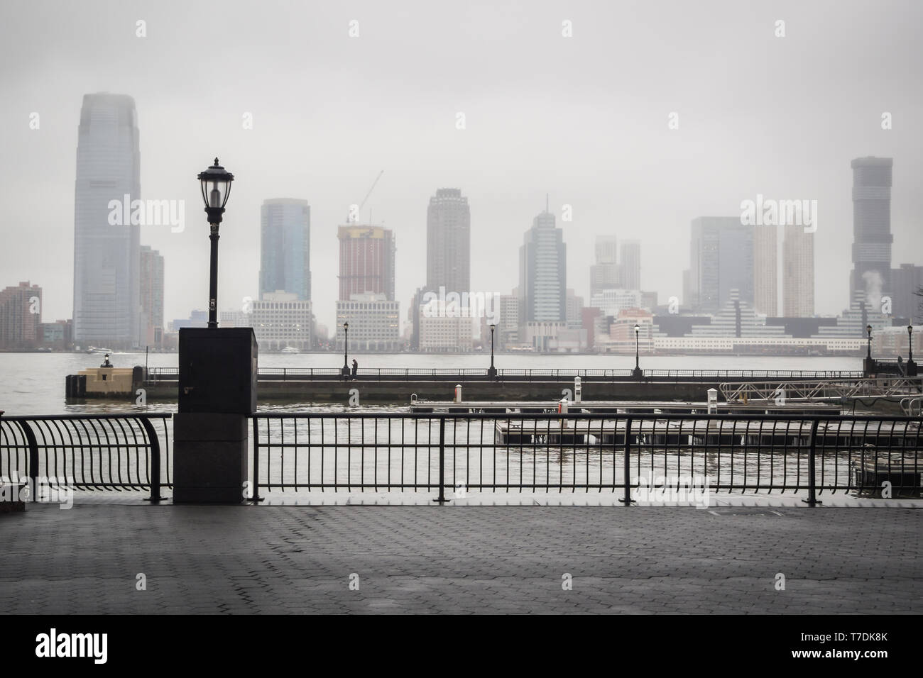 Hudson river docks under the rain overlooking the skyline from the heart of Wall Street in Manhattan, New York Stock Photo