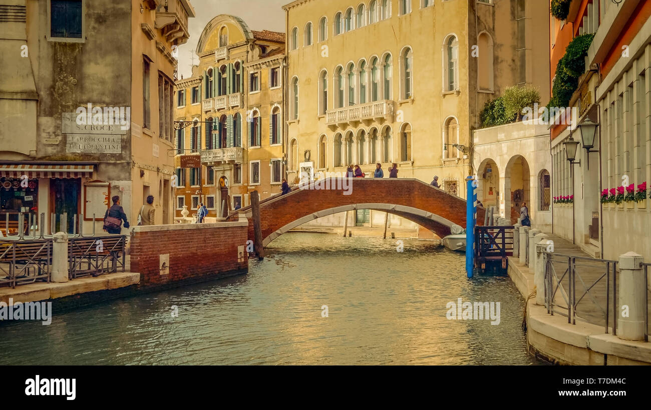 Picturesque brick bridge over small, quiet canal off of the Grand Canal in Venice, Italy Stock Photo