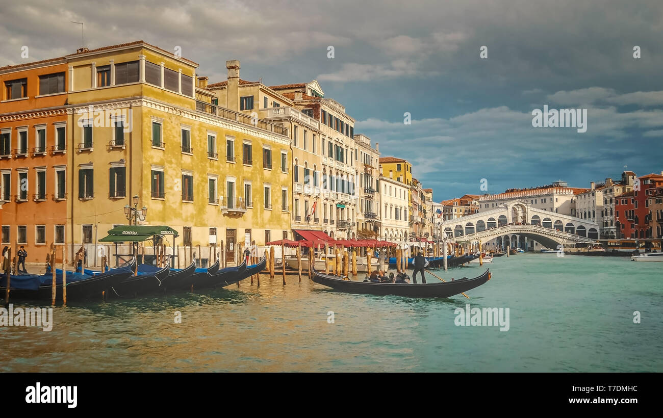 Tourist gondolas in front of Rialto Bridge. Along the Grand Canal in Venice, Italy Stock Photo