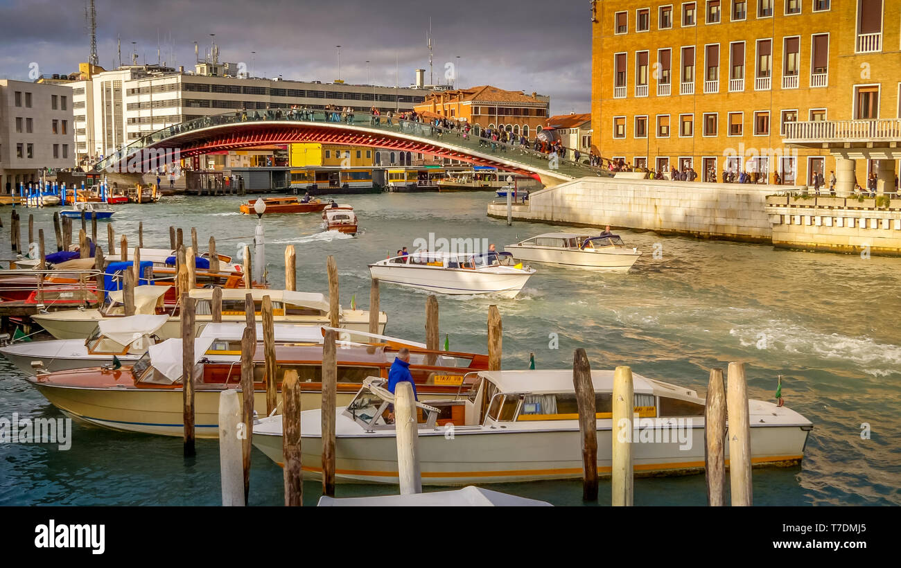 Tourists Cross Constitution Bridge Over Grand Canal, Venice, Italy, faces logos blurred Stock Photo