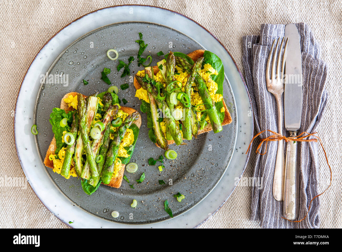 Healthy vegan breakfast plate with spinach, scrambled tofu and green