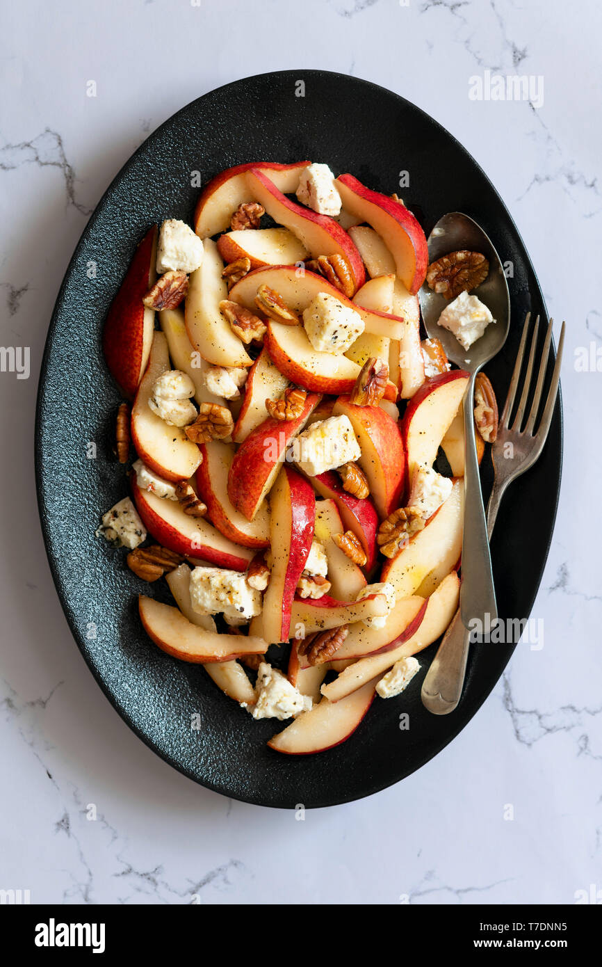 Pear salad with blue vein cheese, walnuts and a spicy dressing on a