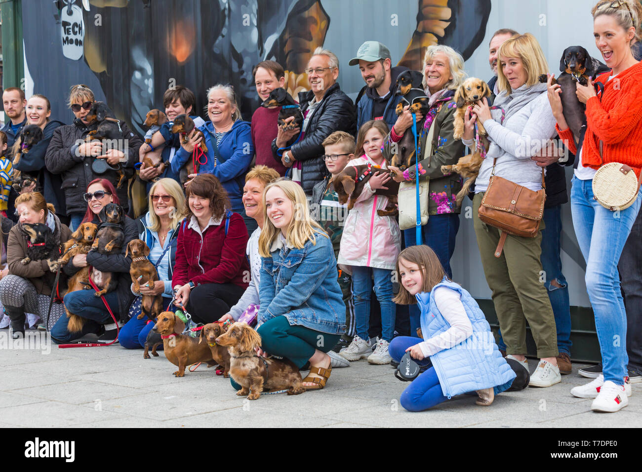 Boscombe, Bournemouth, Dorset, UK. 6th May 2019. Dachshund Dash, part of Bournemouth Emerging Arts Fringe (BEAF) Festival invites dachshunds and their owners to gather under the Daschund artwork to see how many they can gather in one place. Credit: Carolyn Jenkins/Alamy Live News Stock Photo