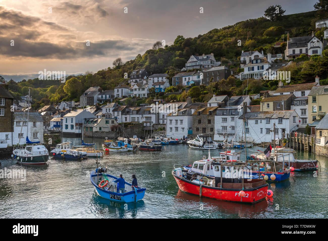Polperro Harbour, Cornwall. 6th May 2019. UK Weather: Bank Holiday Monday. As the sun goes down and the tourists have all gone home, a small boat pulls into the unspoilt pretty fishing harbour at Polperro in south Cornwall. Credit: Terry Mathews/Alamy Live News Stock Photo