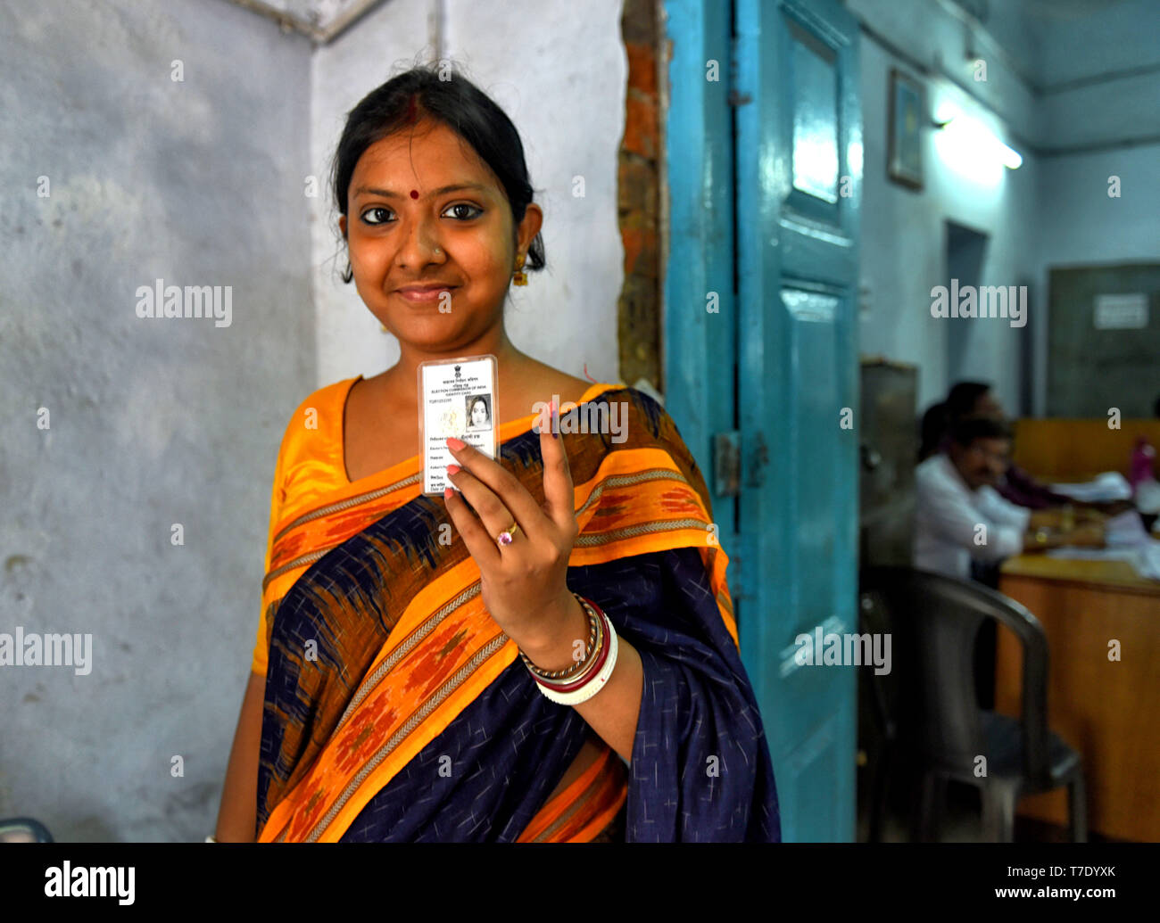 A Young woman seen showing her ink marked finger after casting the vote at a polling station during the 5th Phase of General Elections of India. Stock Photo