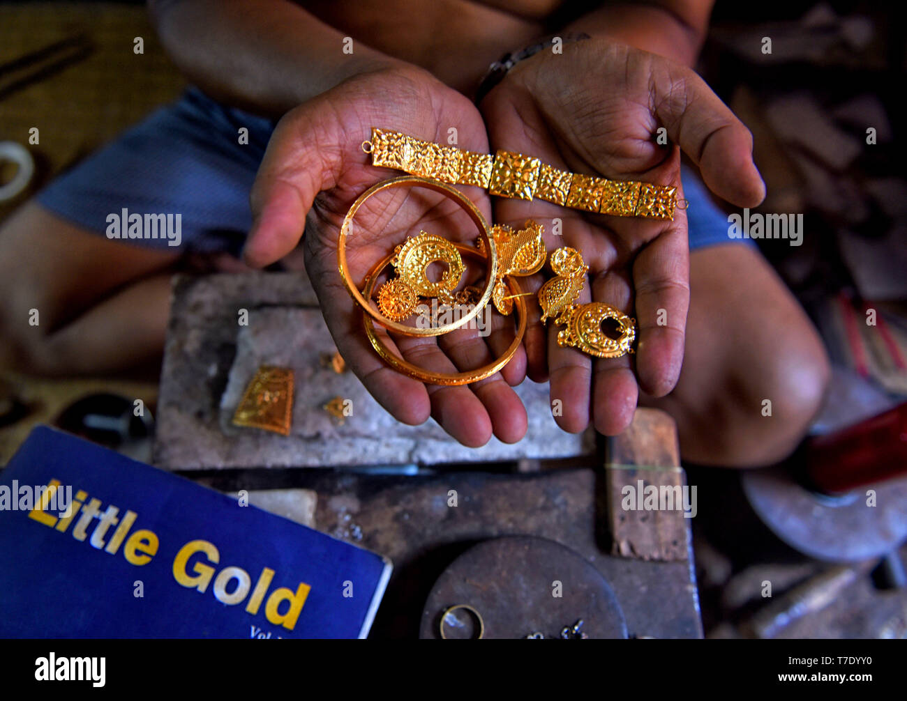 A Goldsmith showing his latest designer works ahead of the Festival. Akshaya Tritiya is a very popular festival among the Hindus and Jains. The most popular activity during the festival is buying of Gold as it is believed that it will bring good fortune for the buyer, as a result demand of Golden jewelry are higher during this time. Stock Photo