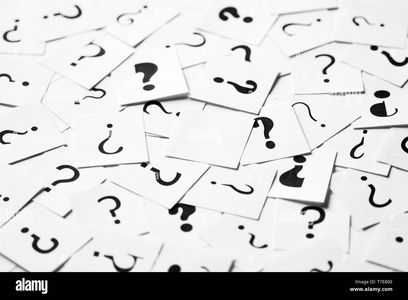Pile of question mark signs scattered around with empty one in the center. Decision, enquiry or faq concept. Stock Photo