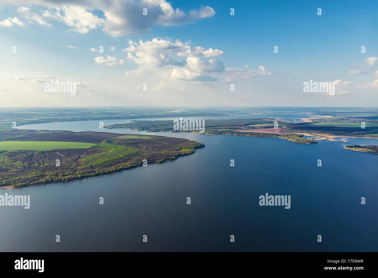 Scenic aerial panoramic landscape of Oskol river curve in eastern Europe with green forest at banks and blue cloudy sky. Natural scenic summer travel  Stock Photo