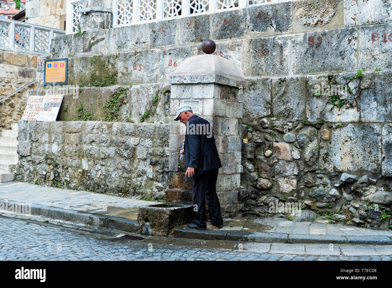 Man washing hands at fountain, Prizren, Kosovo Stock Photo