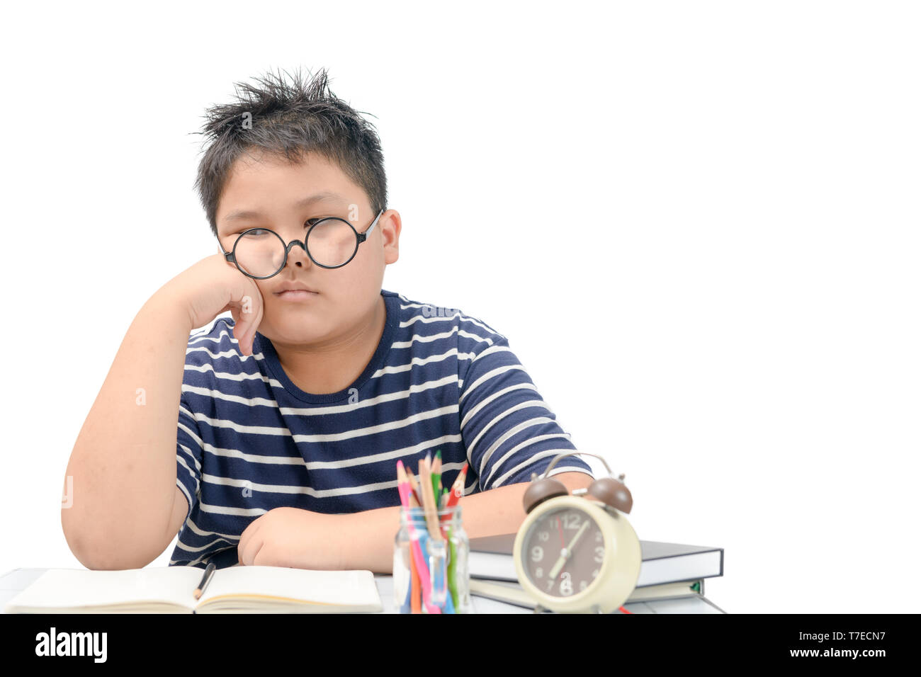 Bored and tired asian student doing homework isolated on white ...