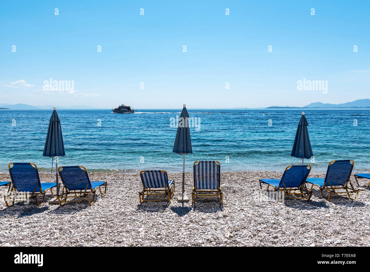 deckchairs, Kaminaki, beach, Nissaki, Corfu Island, Ionian Islands, Mediterranean Sea, Greece Stock Photo